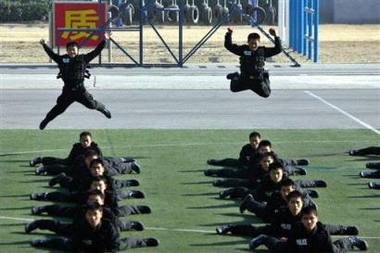 Chinese police officers take part in a security exercise at a special force training base in the south of the city of Beijing, China, Friday, Nov. 25, 2005. 