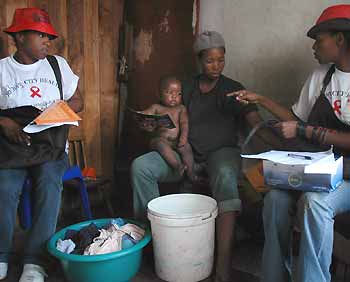 Health care workers speak to residents during a door to door AIDS awareness campaign in Soweto township near Johannesburg, November 29, 2005. The campaign forms part of activities around International AIDS day, which will be commemorated on December 1. According to the United Nations report released last week, South Africa has the world's largest number of AIDS cases, with more than 5 million people infected, about 10 percent of the population.