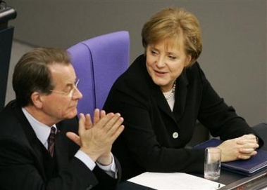 German Chancellor Angela Merkel, right, receives applause from Vice-Chancellor and Labor Minister Franz Muentefering, left, after delivering her first major parliamentary speech in Berlin Wednesday, Nov. 30, 2005 since becoming the country's leader. (AP