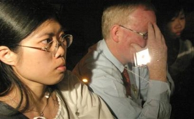 Australian Lawyer Julian McMahon, center, sits in a taxi with Kelly Ng, left, and Browyn Lew, right, friends of Nguyen Tuong Van, as they arrive at the Singapore Changi Prison to support Ngyuen just about an hour before his execution, Friday Dec. 2, 2005 in Singapore.