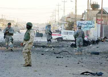 U.S. Army soldiers from the 101st Airborne Division inspect the site of a car bomb in Samara, Iraq Friday, Dec. 2, 2005, which caused no loss of life. In a separate incident ten U.S. Marines were killed and 11 wounded by a roadside bomb near Fallujah on Thursday, which was announced by the Marine Corps on Friday, in the deadliest attack on American troops in three months. (AP 