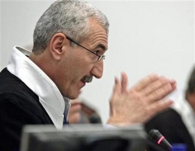 Presiding Judge Rizgar Mohammed Amin speaks to the court as the trial of former Iraqi president Saddam Hussein resumes in Baghdad November 28, 2005.