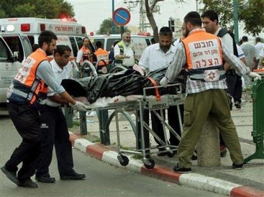 Israeli medics remove a body at the site of a suicide bomb attack in the Israeli coastal city of Netanya Monday Dec. 5, 2005. 