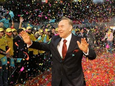 Kazakh President Nursultan Nazarbayev waves to supporters after his landslide victory in Sunday's presidential election was officially announced in the capital of Astana, Monday, Dec. 5, 2005.