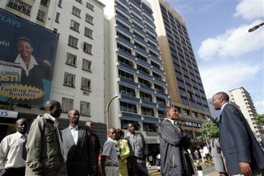 Kenyans gather outside office buildings, Monday, Dec. 5, 2005 after they evacuated the buildings after an earthhquake hit the area.