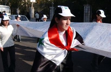 Syrian University students carrying a 1km long piece of cloth signed by Syrian university students to be put infront of the UN headquarters in Damascus on Tuesday, Dec. 6, 2005. The demonstration was held to protest at an interim U.N. commission report, released in October, implicating top Syrian and Lebanese security officials in the death of former Lebanese premier Rafik Hariri. 