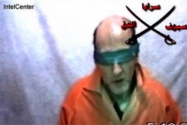 This still image made from video and released Wednesday, Dec. 7, 2005 by IntelCenter, a government contractor that does support work for the U.S. intellegence community, shows Tom Fox, 54, from Clearbrook, Va. 