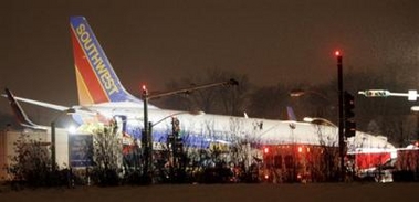 A Southwest Airlines Boeing 737 rests at the intersection of West 55th Street and Central Ave., after it skidded off the runway while trying to land in heavy snow in Chicago, Thursday, Dec. 8, 2005.