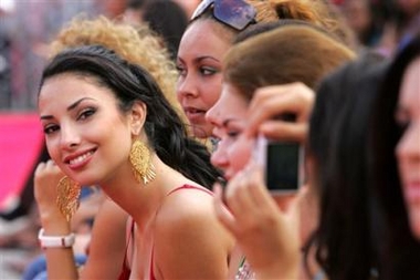 Miss Canada Ramona Rina Amiri smiles for photographers after a tree planting ceremony ahead of the Miss World Final to be held in the Chinese Island resort in Sanya, China, Friday, Dec. 9, 2005.