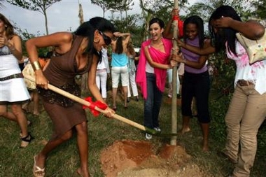 Miss Dominican Republic Elisa Abreu de los Santos, center, laughs as fellow contestants plant a tree during a tree planting ceremony ahead of the Miss World Final to be held in the Chinese Island resort in Sanya, China, Friday, Dec. 9, 2005.