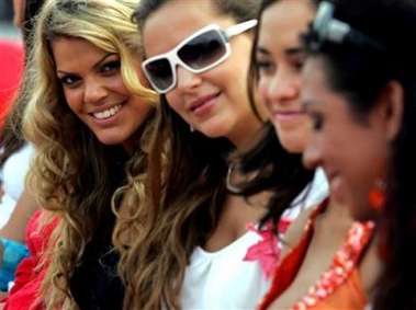 Miss Israel Karem Sacham, left, smiles for photographers after a tree planting ceremony ahead of the Miss World Final to be held in the Chinese Island resort in Sanya, China, Friday, Dec. 9, 2005.