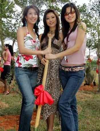 From left: Miss South Korea Oh Eun-Young, Miss Japan Erina Shinohara, Miss China Zhao Ting Ting smile for photographers during a tree planting ceremony ahead of the Miss World Final to be held in the Chinese Island resort in Sanya, China, Friday, Dec. 9, 2005.