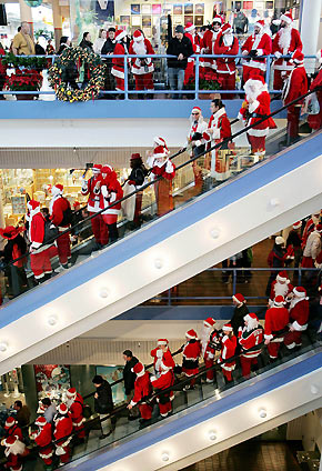 dHundreds of Santas leave the South Street Seaport after their first drink of the day in New York December 10, 2005. They were participating in the annual New York SantaCon, which involves hundreds of people in cheap Santa suits walking around the city, singing naughty carols, drinking, and generally spreading holiday cheer and mayhem.