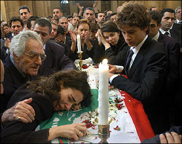Nayla(L), daughter of slain anti-Syrian lawmaker and press magnate Gibran Tueini, cries over her father's coffin during his funeral in Beirut.
