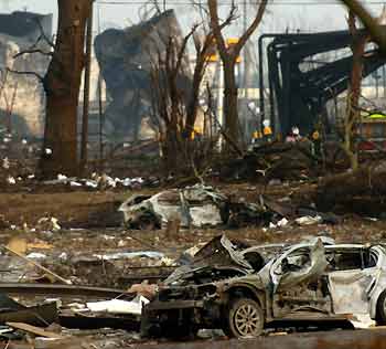 A burnt-out car sits in a car-park on the Maylands industrial park by the Buncefield fuel depot at Hemel Hempstead near London on December 14, 2005. Safety inspectors said on Wednesday they would begin an investigation into the cause of a massive blaze at the Buncefield oil depot north of London now that fire crews had quenched the flames. [Reuters]