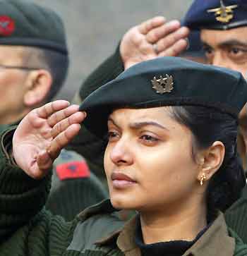 An Indian army officer salutes at a war memorial during 'Vijay Divas' or victory day celebrations in a garrison in Srinagar December 16, 2005. Vijay Divas is celebrated to mark the victory of the Indian army in the 1971 war with Pakistan and to remember those who sacrificed their lives for the nation, an Indian army statement said.