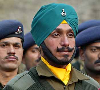 Indian army soldiers stand at a war memorial during 'Vijay Divas' or victory day celebrations in a garrison in Srinagar December 16, 2005. [Reuters]