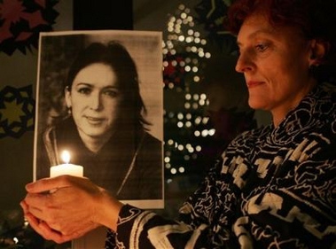 Angela Gottwald from Glonn, southern Germany, holds a candle in front of a picture of the kidnapped German archaeologist Susanne Osthoff during a solemn vigil in Glonn in this Monday, Dec. 5, 2005 file photo.