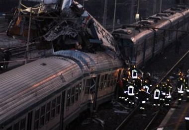 Firemen are seen at work after two passengers trains collided at the station in Roccasecca, Italy, about 130 kilometers (80 miles) south of Rome, Tuesday, Dec. 20, 2005