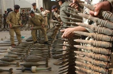 Iraqi soldiers display an array of weapons at the customs police headquarters in Najaf, Iraq, Sunday Dec. 18, 2005. The weapons cache was found in the desert some 70 kilometers ( 43 miles ) west of Najaf.