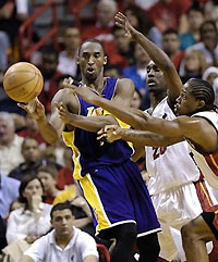 Los Angeles Lakers' Koby Bryant pass to a teammate as Miami Heat's Gary Payton, center, and Udonis Haslem apply pressure during the fourth quarter of an NBA basketball game, Sunday, Dec. 25, 2005, in Miami.