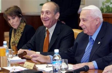 Israeli Prime Minister Ariel Sharon (R), Vice-Premier and Finance Minister Ehud Olmert (C) and Education Minister Limor Livnat (L) attend the weekly cabinet meeting in Jerusalem December 25, 2005.