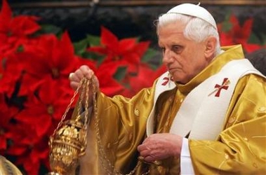 Pope Benedict XVI arrives to lead the midnight mass in Saint Peter's Basilica at the Vatican, December 25, 2005.