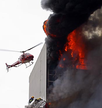 Brazilian fire workers combat fire at the government's social security archives building in Brasilia December 27, 2005. No victims were reported. 