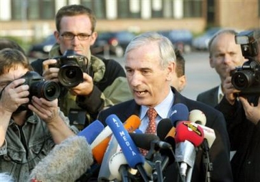 Juergen Chrobog, German Deputy Foreign Secretary, who helped to negotiate the release of the 14 hostages that arrived from Mali at the military airport in Cologne, western Germany, on Aug. 20, 2003, speaks with journalists.