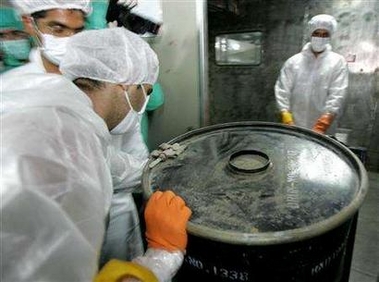 An Iranian worker lifts a barrel of 'yellow cake' to feed it into the processing line of Uranium Conversion Facility (UCF) in Isfahan, Iran August 8, 2005. 