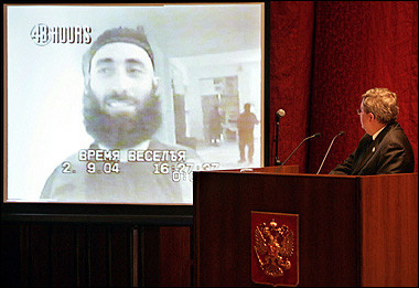 Alexander Torshin (R), head of the Russian parliamentary probe of the Beslan crisis and deputy speaker of the Federation Council shows a militant video made 02 September 2004 by hostage-takers inside the school #1, as he presents the parliamentary commission's investigation to senators in Moscow. 