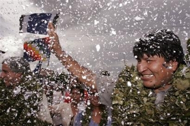 Wearing a wreath of coca leaves Bolivia's president-elect, Evo Morales, waves to supporters during a visit to Eterazama, in the coca growing region of Chapare, Wednesday, Dec. 28, 2005.