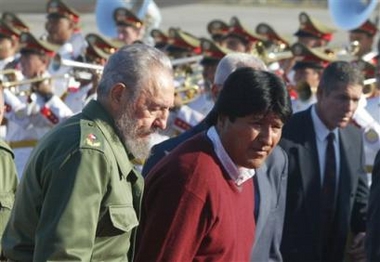 Cuban President Fidel Castro, left, and Bolivian President-elect Evo Morales walk the red carpet to review honor guard at the Jose Marti International Airport in Havana,Cuba, Friday,Dec.30,2005.