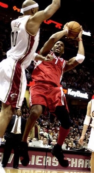 Tracy McGrady (1) of the Houston Rockets scores two points over Drew Gooden (90) of the Cleveland Cavaliers in the third quarter of their NBA game at The Q in Cleveland, Ohio January 5, 2006.