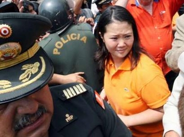 Keiko Fujimori, daughter of former Peruvian president Alberto Fujimori, is dressed in the ex-president's trademark political color orange as she leaves Peru's National Electoral Board in Lima January 6, 2006. Keiko registered her father to run for Peruvian president in April as Chile opened investigations to extradite him for corruption and human rights abuses. 