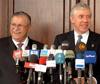 Iraqi President Jalal Talabani (L) and British Foreign Secretary Jack Straw listen during a news conference at the fortified Green Zone in Baghdad January 7, 2006.