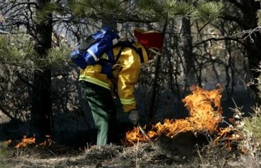 A firefighter works a hotspot on a wildfire near Aguilar, Colo., on Sunday, Jan. 8, 2006.