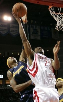 Denver Nuggets' Carmelo Anthony, left, blocks the shot of Houston Rockets' Luther Head (2) during the second quarter of their NBA basketball game Sunday, Jan. 8, 2006, in Houston.