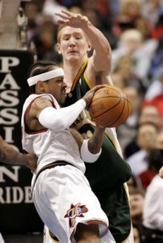 Seattle Supersonics' Robert Swift, rear,guards Philadelphia 76ers' Allen Iverson in the first half of their NBA basketball game Monday, Jan. 9, 2006, in Philadelphia.