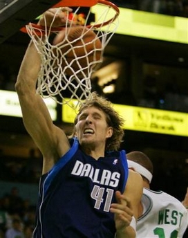 Dallas Mavericks' Dirk Nowitzki of Germany (41) dunks the ball against Boston Celtics' Delonte West during the fourth quarter of their NBA basketball game in Boston Monday, Jan. 9, 2006.