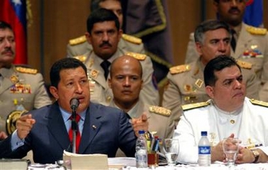 In this photo released by Venezuela's Miraflores Press, Venezuela's President Hugo Chavez, left, speaks at the inauguration of the new military academic year as his Defense Minister Orlando Maniglia sits to his right in Caracas, Venezuela, Tuesday, Jan. 10, 2006. 