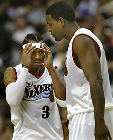 Philadelphia 76ers Chris Webber,right, consoles teammate Allen Iverson late in the fourth quarter as they lose 110-102 to the Utah Jazz in their NBA basketball game Wednesday, Jan. 11, 2006 in Philadelphia.