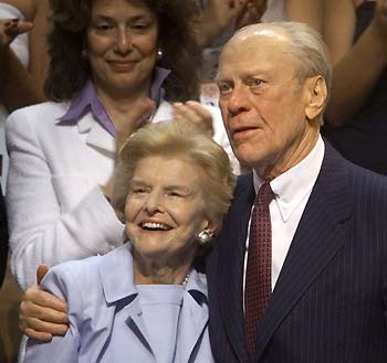 Former U.S. President Gerald Ford (R) stands with his wife Betty following a tribute in his honor at the Republican National Convention in Philadelphia in this August 1, 2000 file photo.