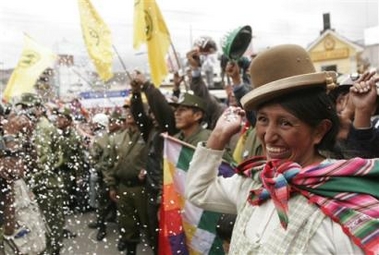 An indigenous woman throws confetti as Bolivia's new president Evo Morales passes by in La Paz, Sunday, Jan 22, 2006.