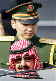 Saudi King Abdullah (C) is helped into his car by a Chinese PLA soldier after arriving in Beijing, to begin a four-day visit in which he will discuss oil and energy security with leaders of the world's top oil consuming nation.(AFP