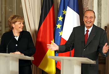 France's President Jacques Chirac (R) and German Chancellor Angela Merkel answer reporters' questions after talks in Versailles, western Paris January 23, 2006.
