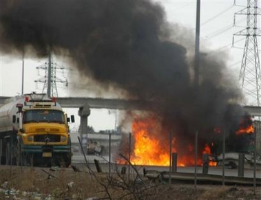 A fuel tanker burns after being hit with gunfire from unknown attackers, Thursday, Jan. 26, 2006, in Baghdad, Iraq.