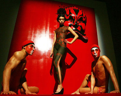 A tableau by designer Vivienne Tam features models in body makeup in the style of the Chinese Qi Pao dress at a Chinese New Year celebration MAC fashion show in New York February 2, 2006. The elaborate makeup applications took up to eight hours to apply on the topless models who then posed in front of backdrops at a cocktail party. The show kicks off Fashion Week which starts on Friday.