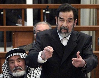 Former Iraqi President Saddam Hussein argues with chief Judge Raouf Abdel-Rahman after his half brother, Barzan Ibrahim, not seen, was forcibly removed from the trial held in Baghdad's heavily fortified Green Zone, Sunday Jan. 29, 2006.