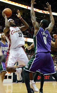 LeBron James (23) of the Cleveland Cavaliers scores in front of Joe Smith (8) of the Milwaukee Bucks during the second quarter of their NBA game at in Cleveland, Ohio, February 6, 2006. James scored 22 points to lead the Cavaliers to a 89-86 victory over the Bucks.